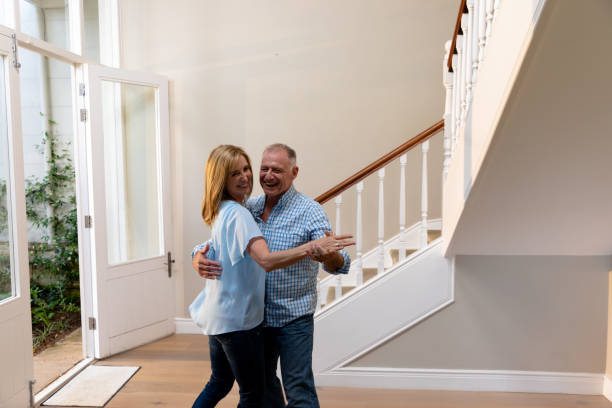 istock Caucasian couple having fun dancing and smiling in the hallway 1253626381