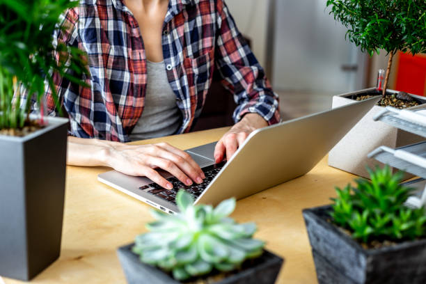 istock Close up girl writing on a laptop - working from home 1253626524