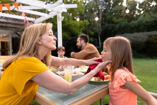 istock Happy family eating together at table 1253627307
