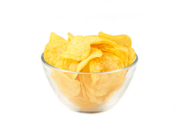 istock Potato chips on bowl isolated on white background 1253629603