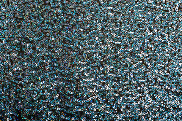 istock Dark festive background of blue shiny sequins. 1253631479