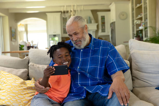 istock Senior mixed race man with his grandson taking a selfie 1253631740