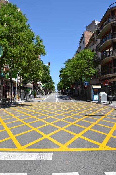 istock Asphalt road texture with yellow stripes after covid lockdown in Barcelona 1253632025