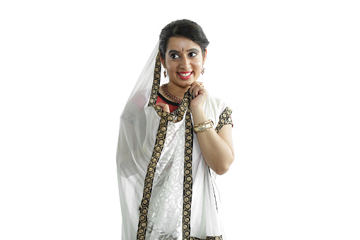 Beautiful young woman in traditional ghagra and choli performing rajasthani or gujarati folk dance.