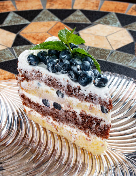 Cake with sour cream and blueberries. On a stone decorative table