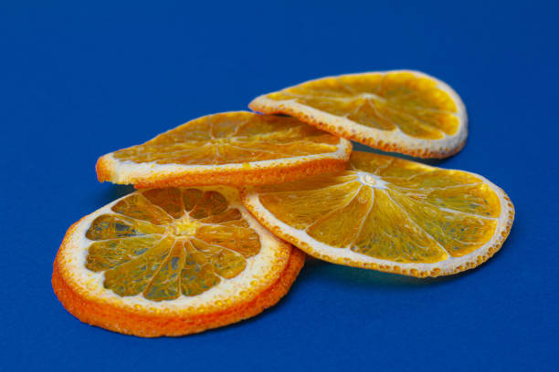 istock dried orange slices isolated on blue background 1253635291