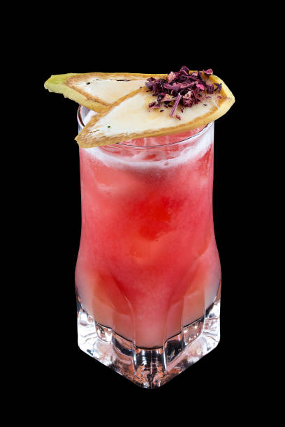 istock Refreshing cocktail in a glass on a black background. Passion fruit and pear 1253636108