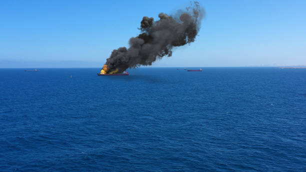 Cargo ship burning on fire with large scale smoke-Aerial Aerial, Mediterranean Sea, Cargo tanker ship, Real Drone view with visual effect Elements fire ship stock pictures, royalty-free photos & images