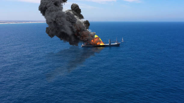 istock Cargo ship burning on fire with large scale smoke-Aerial 1253637402