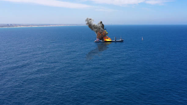 istock Cargo ship burning on fire with large scale smoke-Aerial 1253637447