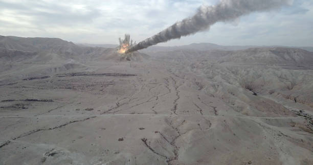 istock Meteor Asteroid Crashing in the Desert Mountain 1253639311