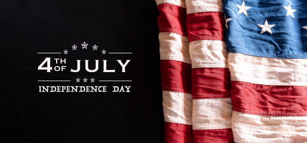 istock Happy Independence Day. American flags against a black  background. July 4. 1253639644