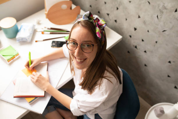 istock Young woman studying at home 1253641768