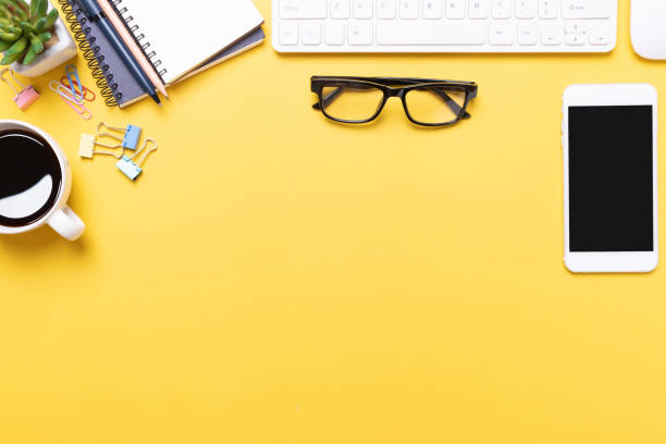 istock Workplace of yellow office desk table 1253645873
