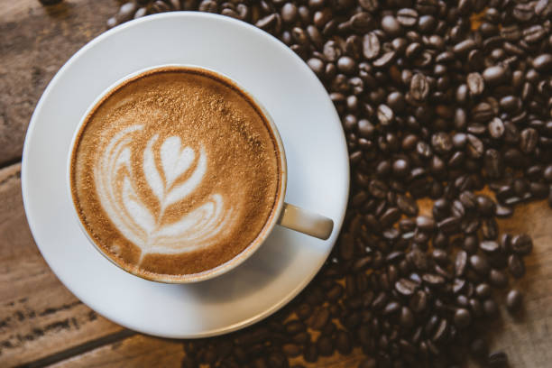 istock A cup of coffee with heart pattern in a white cup on wooden background 1253649262