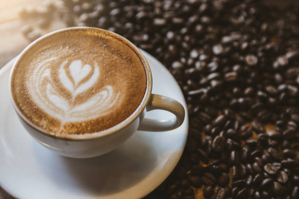 istock A cup of coffee with heart pattern in a white cup on wooden background 1253649281