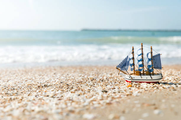 istock Ship model on summer sunny beach. Travel, voyage, vacation concepts 1253649327