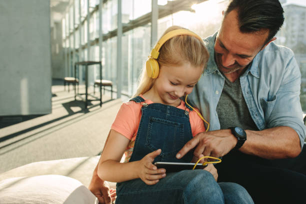 istock Passing the time with digital tablet at airport lounge 1253649425