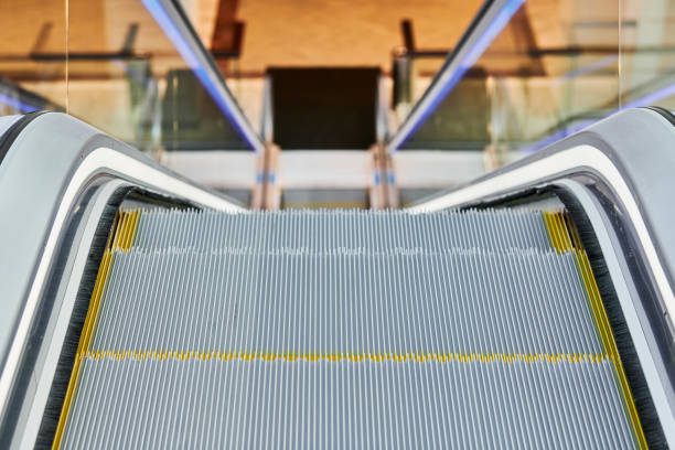Escalator in shopping center. Close up escalators stairs up and down in office building, shopping mall or subway station.
