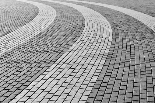 Circle tile road. Stone pavers in city park. Paving stones for walkways and sidewalk. Outdoor surface. Rhythm of photography