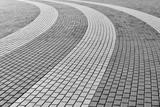 Photo of Circle tile road. Stone pavers in city park