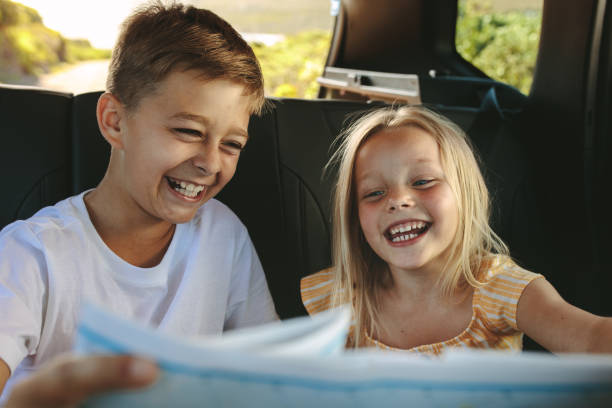 istock Happy playful kids travelling by car 1253651324