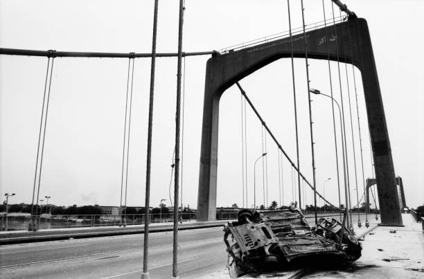 Tigris bridge which was shot during the 2003 Gulf War in Baghdad. On the bridge there is a car which was bombed. Photographed by Michael Multhoff in Baghdad / Iraq. May 12, 2003