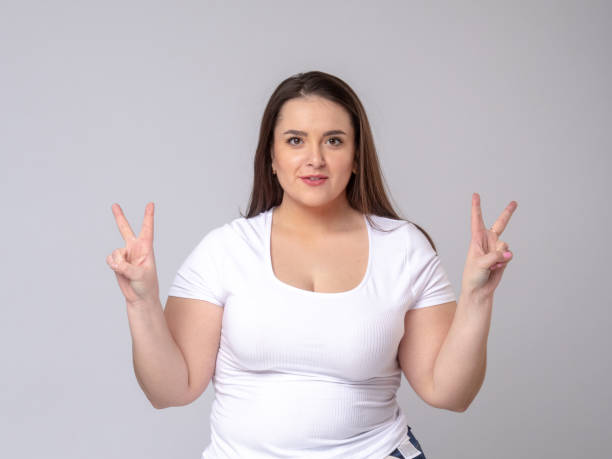 istock Shocked Plus Size Model with long hair posing in studio. v -symbol 1253652771