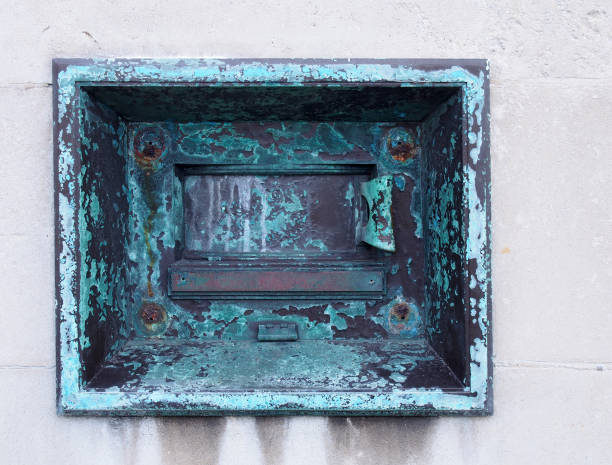 an old metal outdoor overnight deposit box also known as a night safe, once common on the outside walls of banks - night deposit box imagens e fotografias de stock