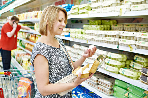 istock Woman buy eggs in shop 1253663178