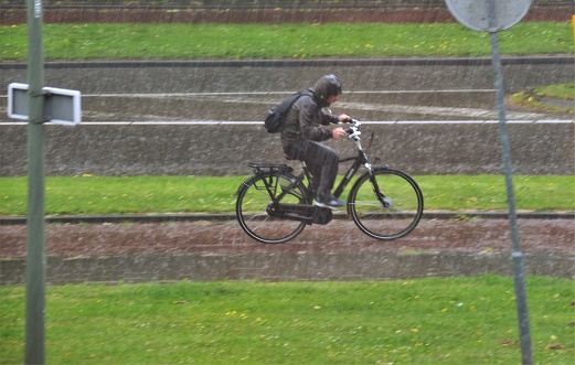 Brunssum, the Netherlands, - July 01, 20184. Biker in heavy rain on his way home.