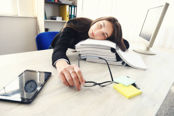 istock Tired businesswoman working in an office 1253666514