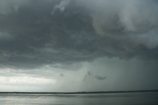 istock Storm Clouds and Cloud burst rain over the Ocean 1253666538