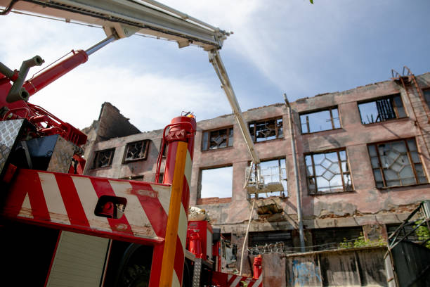istock Telescopic lift of a fire engine with a detachment with a burning building 1253666561