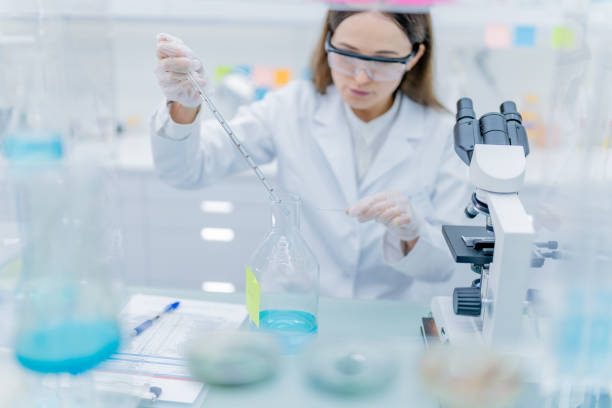 istock Female scientist during research. Studying samples in futuristic laboratory 1253668517