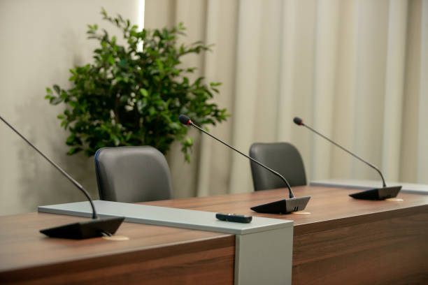 istock Conference microphones in a meeting room 1253668570