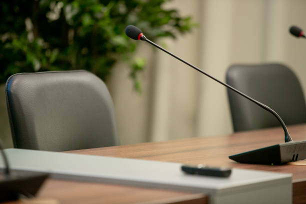 istock Conference microphones in a meeting room 1253669476