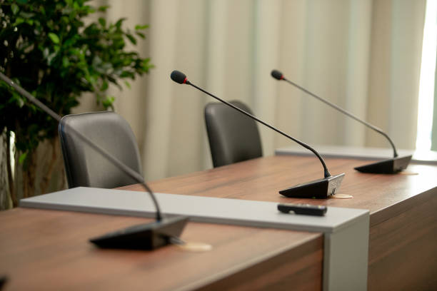 istock Conference microphones in a meeting room 1253669486
