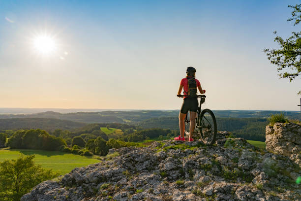 istock young woman with mountain bike at viewpoint 1253673921