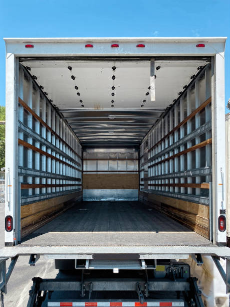 Empty moving truck with rear doors openedith rear doors opened Empty moving van with rear doors opened vehicle interior photos stock pictures, royalty-free photos & images