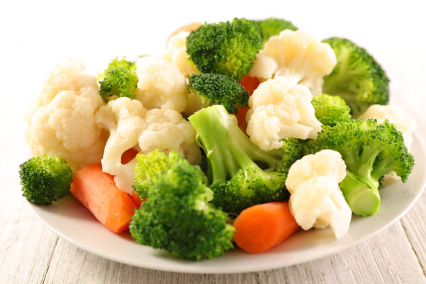 istock plate with broccoli, cauliflower and carrot 1253674963