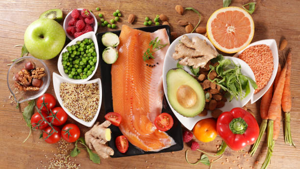 istock selection of healthy food- fruit, vegetable, fish, nut, cereal 1253674991