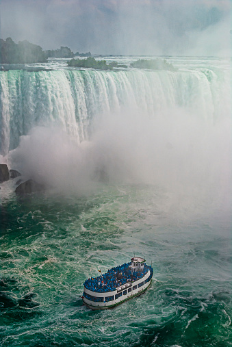 Image of Stunning Niagara Falls view of Horseshoe Falls with ship for tourists approaching mist