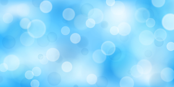 Abstract background with bokeh effects in light blue colors