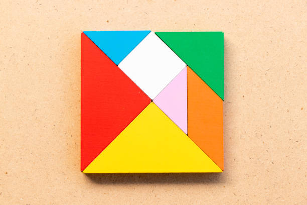 Color tangram puzzle in square shape on wood bacground
