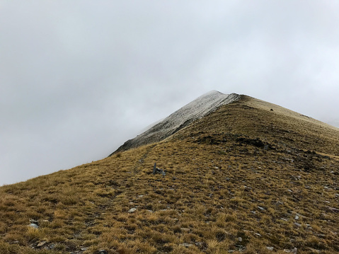 Peak of a mountain with its clowds on top