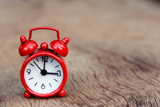 istock Red alarm clock on wood background with copy space 1253679065