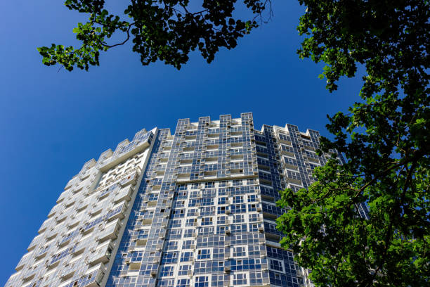 istock High-rise building with a view of the blue sky from below. 1253679375