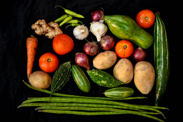 istock Vegetables on the background. Fresh vegetables (cucumbers, tomatoes, onions, garlic, dill, green beans) on a gray background. Top view. Copy space 1253680954