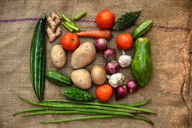 istock Vegetables on the background. Fresh vegetables (cucumbers, tomatoes, onions, garlic, dill, green beans) on a gray background. Top view. Copy space 1253681484